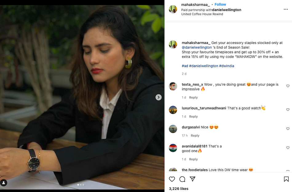 An Instagram post by micro-influencer includes a photo of her wearing a Daniel Wellington watch publicizing a discount offer as part of the watch manufacturer's influencer partnership strategy.