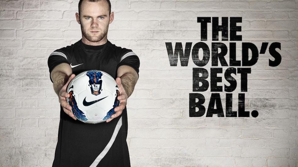 English soccer player wayne rooney holds a soccer ball in front of him facing the camera next to the words the world's best ball.